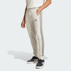 Essentials French Terry Tapered Cuff 3-Stripes Pants. Białe spodnie sportowe męskie Adidas, bez wzorów, z dresówki, na fitness i siłownię. Za 182.00 zł.