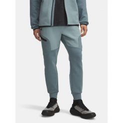 Spodnie Dresowe Męskie Under Armour. Niebieskie spodnie sportowe męskie Under Armour, m, bez wzorów, z dresówki, na fitness i siłownię. Za 199.99 zł.