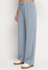 Niebieskie Szerokie Spodnie z Wysokim Stanem i Wiązaniem Deannie. Niebieskie spodnie materiałowe damskie Born2be, bez wzorów, z gumy, eleganckie, z podwyższonym stanem. Za 54.99 zł.