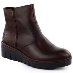 Skórzane botki damskie na koturnie brązowe Rieker X9165-27. Brązowe botki damskie Rieker, bez wzorów, ze skóry, bez obcasa, na koturnie, bez zapięcia. Za 272.35 zł.