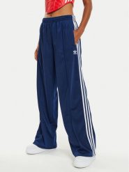 Adidas Spodnie dresowe Firebird IL3817 Granatowy Loose Fit. Niebieskie spodnie dresowe damskie Adidas, bez wzorów, z dresówki. Za 239.99 zł.