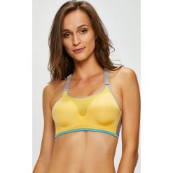 Triumph - Biustonosz Triaction Magic Motion. Żółte bielizna sportowa damska Triumph, bez wzorów, z bawełny. W wyprzedaży za 149.90 zł.