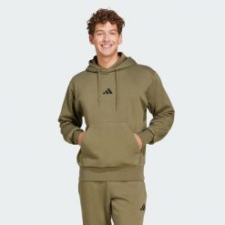 Bluza polarowa Essentials Feelcozy. Czarne bluzy damskie Adidas, m, bez wzorów, z bawełny, klasyczne, bez ramiączek, z kapturem. Za 219.00 zł.