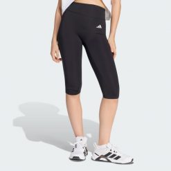 Legginsy Optime Essentials Capri. Czarne legginsy damskie Adidas, bez wzorów, z elastanu. Za 199.00 zł.
