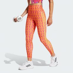 Legginsy adidas x FARM Rio 7/8. Czerwone legginsy damskie Adidas, bez wzorów, z materiału. W wyprzedaży za 139.50 zł.