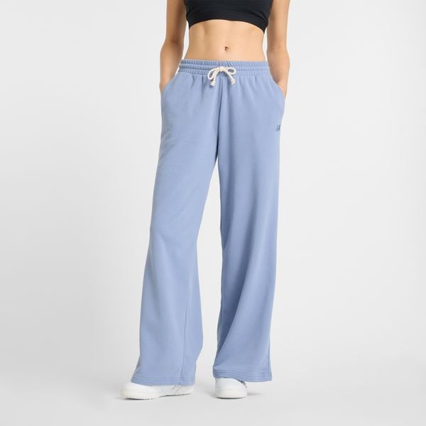 Spodnie damskie New Balance WP51503DUS – niebieskie. Niebieskie spodnie materiałowe damskie New Balance, z aplikacjami, z bawełny, klasyczne. Za 249.99 zł.