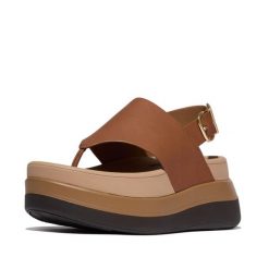 Kobiece sandały na koturnie ze skórzaną tylną paskiem FitFlop F-Mode. Czarne sandały damskie FIT FLOP, bez wzorów, z materiału, bez obcasa, na koturnie, bez zapięcia. Za 601.50 zł.