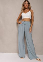 Jasnoniebieskie Szerokie Spodnie z Wiskozy i Gumką w Pasie Abyga. Niebieskie spodnie materiałowe damskie Renee, bez wzorów, z jeansu, biznesowe. Za 44.99 zł.