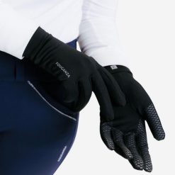 Rękawiczki jeździeckie 100. Czarne rękawiczki męskie FOUGANZA, bez wzorów, z dzianiny. Za 39.99 zł.