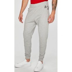 Reebok - Spodnie. Szare spodnie sportowe męskie Reebok, l, bez wzorów, z bawełny, climacool (adidas). W wyprzedaży za 199.90 zł.
