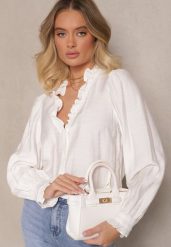 Biała Wiskozowa Koszula Zdobiona Falbankami Hanerina. Białe koszule damskie Renee, l, z aplikacjami, z jeansu, eleganckie, bez kołnierzyka, bez ramiączek. Za 89.99 zł.