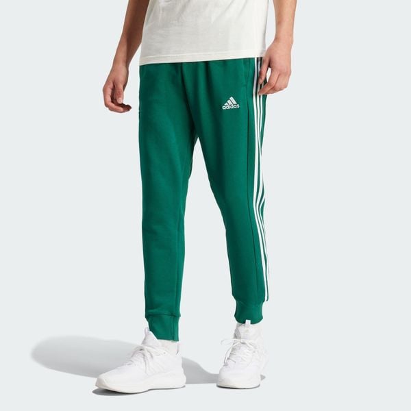 Spodnie dresowe męskie adidas Essentials French Terry Tapered Cuff 3-Stripes. Zielone spodnie sportowe męskie Adidas, m, bez wzorów, z dresówki, na jogę i pilates. Za 195.49 zł.