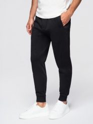 Męskie spodnie dresowe typu jogger - czarne V5 - Rozmiar: L. Czarne spodnie sportowe męskie Ombre Clothing, l, bez wzorów, z bawełny. W wyprzedaży za 101.24 zł.