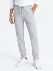 Męskie spodnie dresowe o marchewkowym kroju - szary melanż V3. Szare spodnie sportowe męskie Ombre Clothing, m, bez wzorów, z dresówki. W wyprzedaży za 59.99 zł.