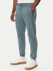 Guess Spodnie dresowe Z2YB19 K6ZS1 Niebieski Regular Fit. Niebieskie spodnie sportowe męskie Guess, m, z aplikacjami, z bawełny. Za 344.99 zł.