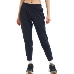 Spodnie sportowe damskie Under Armour Unstoppable Jogger. Czarne spodnie dresowe damskie Under Armour, bez wzorów, z dresówki, sportowe, do biegania. Za 512.00 zł.