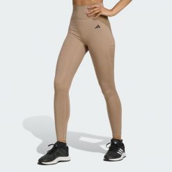 Legginsy 7/8 bez szwu z przodu Optime Essentials. Brązowe legginsy damskie Adidas, bez wzorów. W wyprzedaży za 142.35 zł.