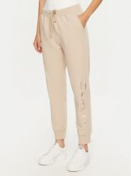 Champion Spodnie dresowe 117584 Beżowy Slim Fit. Brązowe spodnie dresowe damskie Champion, bez wzorów, z bawełny. Za 159.99 zł.