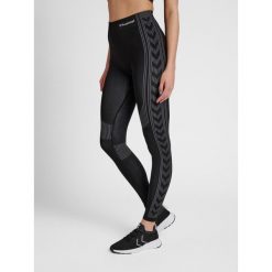 Damskie legginsy ze średnim stanem Hummel Shaping. Czarne legginsy damskie Hummel, bez wzorów, z dzianiny. Za 128.00 zł.