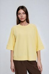 Bluza z krótkimi i szerokimi rękawami żółta. Żółte bluzy damskie MOODO, l, bez wzorów, z bawełny, bez ramiączek, bez kaptura. Za 89.99 zł.