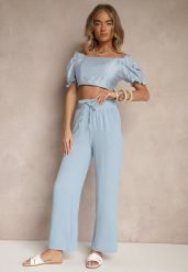 Jasnoniebieskie Szerokie Spodnie High Waist z Gumką w Pasie Savimirae. Niebieskie spodnie materiałowe damskie Renee, bez wzorów, z jeansu, eleganckie, z podwyższonym stanem. Za 39.99 zł.
