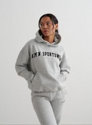 Damska bluza z kapturem, drapany polar, luźny Varsity Sweat Hood szary melanż. Szare bluzy damskie Aim'n, l, bez wzorów, z bawełny, sportowe, bez ramiączek, z kapturem. Za 339.00 zł.