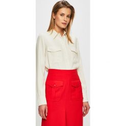 Calvin Klein - Koszula. Białe koszule damskie Calvin Klein, bez wzorów, z materiału, klasyczne, bez kołnierzyka, bez ramiączek. W wyprzedaży za 429.90 zł.