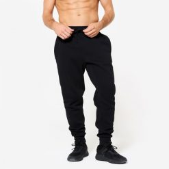 Spodnie fitness męskie Domyos Gym & Pilates slim. Niebieskie spodnie sportowe męskie DOMYOS, m, bez wzorów, z dresówki, na fitness i siłownię. Za 79.99 zł.