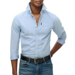 Wyblakana koszula Superdry Oxford. Niebieskie koszule męskie Superdry, xl, bez wzorów, z bawełny, casualowe, bez kołnierzyka, bez ramiączek. Za 295.45 zł.