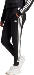Adidas Spodnie damskie Essentials 3-Stripes Fleece Slim czarno-biały JX2543 XS. Białe spodnie dresowe damskie Adidas, bez wzorów, sportowe. Za 236.08 zł.