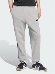 Adidas Spodnie dresowe Essentials 3-Stripes KY4195 Szary jasny Regular Fit. Szare spodnie sportowe męskie Adidas, m, bez wzorów, z bawełny. Za 219.99 zł.