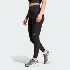 Legginsy Own the Run 7/8. Czarne legginsy damskie Adidas, bez wzorów, z materiału. W wyprzedaży za 209.25 zł.