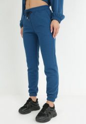 Ciemnoniebieskie Spodnie Dresowe z Tłoczeniem Faboto. Niebieskie spodnie dresowe damskie Born2be, bez wzorów, z dresówki, eleganckie. Za 74.99 zł.