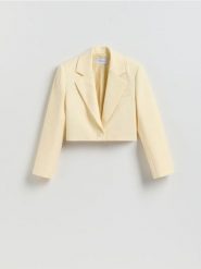 Krótka marynarka - jasnożółty. Żółte marynarki i żakiety damskie Reserved, bez wzorów, z tkaniny, bez kołnierzyka, bez ramiączek. Za 179.99 zł.