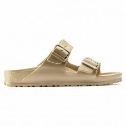 Klapki Birkenstock Arizona 1022465 złoty. Żółte klapki damskie bez wzorów, z materiału, klasyczne, bez obcasa, bez zapięcia. Za 361.45 zł.