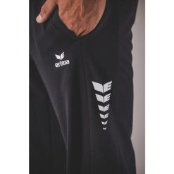 Spodnie dresowe Erima Cmpt Wings Gk czarne. Czarne spodnie sportowe męskie Erima, bez wzorów, z dresówki, do piłki nożnej. Za 318.99 zł.