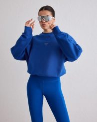 Damska bluza biegowa oddychająca, odprowadzająca wilgoć Le Run błękitna. Niebieskie bluzy damskie Aim'n, l, bez wzorów, z bawełny, bez ramiączek, bez kaptura. Za 381.00 zł.