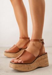 Brązowe Sandały VICES na Koturnie z Imitacji Korka z Paskiem wokół Kostki Kelania. Brązowe sandały damskie Born2be, bez wzorów, bez obcasa, na koturnie, bez zapięcia. Za 119.99 zł.