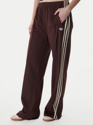 Adidas Spodnie dresowe Firebird KG3706 Brązowy Loose Fit. Brązowe spodnie dresowe damskie Adidas, bez wzorów, z dresówki. Za 299.99 zł.
