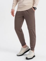 Spodnie męskie dresowe z przeszyciem i zamkiem na nogawce - brązowe V4. Brązowe spodnie sportowe męskie Ombre Clothing, m, bez wzorów, z bawełny. W wyprzedaży za 69.99 zł.
