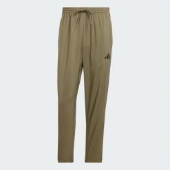 Spodnie Essentials 3-Stripes Stanford Open Hem. Brązowe buty sportowe męskie Adidas, l, bez wzorów, z materiału, na fitness i siłownię. Za 179.00 zł.
