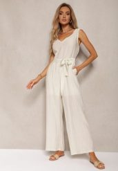 Jasnobeżowy Kombinezon z Wiskozy z Szerokimi Nogawkami z Gumką w Pasie i Materiałowym Paskiem Acladia. Brązowe sukienki damskie Renee, l, bez wzorów, z materiału, eleganckie, bez kołnierzyka, bez ramiączek. Za 109.99 zł.