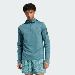 Bluza z kapturem Own The Run Winterized Hooded Half-Zip. Niebieskie bluzy męskie Adidas, s, bez wzorów, z kapturem, do biegania, ClimaWarm (Adidas). Za 279.99 zł.