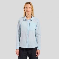 Koszula z długim rękawem damska ODLO Shirt l/s ESSENTIAL. Niebieskie koszule damskie ODLO, l, bez wzorów, z materiału, klasyczne, bez kołnierzyka, bez ramiączek. Za 409.99 zł.