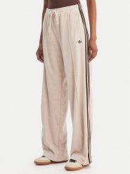 Adidas Spodnie dresowe Terry Towel Firebird KQ6661 Beżowy Loose Fit. Brązowe spodnie dresowe damskie Adidas, bez wzorów, z bawełny. Za 349.99 zł.