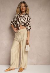 Beżowe Spodnie Typu Palazzo o Szerokim Kroju High Waist Ozdobione Wiązaniem Yaslevia. Brązowe spodnie materiałowe damskie Renee, bez wzorów, z jeansu, eleganckie, z podwyższonym stanem. Za 39.99 zł.