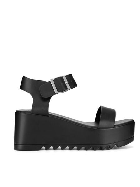 JENNY Sandały WFA1383-1 Czarny. Czarne sandały damskie Jenny, bez wzorów, z syntetyku, bez obcasa, na koturnie, bez zapięcia. Za 139.99 zł.