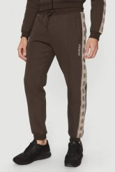 GUESS Brązowe męskie spodnie dresowe z lampasami Mickey. Brązowe spodnie sportowe męskie Guess, l, z aplikacjami, z dresówki. W wyprzedaży za 355.99 zł.