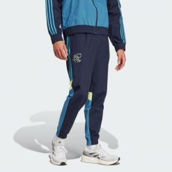 Spodnie dresowe Ajax Amsterdam Seasonal. Niebieskie spodnie sportowe męskie Adidas, xl, bez wzorów, z dresówki, do piłki nożnej. W wyprzedaży za 230.30 zł.