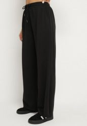 Czarne Spodnie z Gumką w Pasie i Wsuwanymi Kieszeniami Tosille. Czarne spodnie materiałowe damskie Born2be, bez wzorów, z jeansu, eleganckie. Za 69.99 zł.